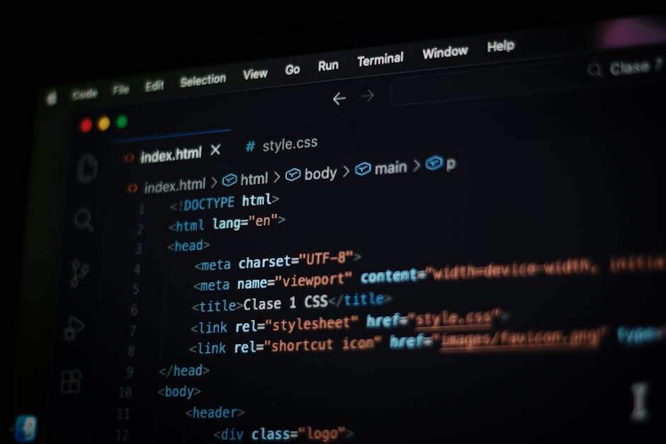 A close-up view of a computer screen displaying HTML code, including tags such as <html>, <head>, <title>, and <link>, with a dark background and colorful syntax highlighting. 