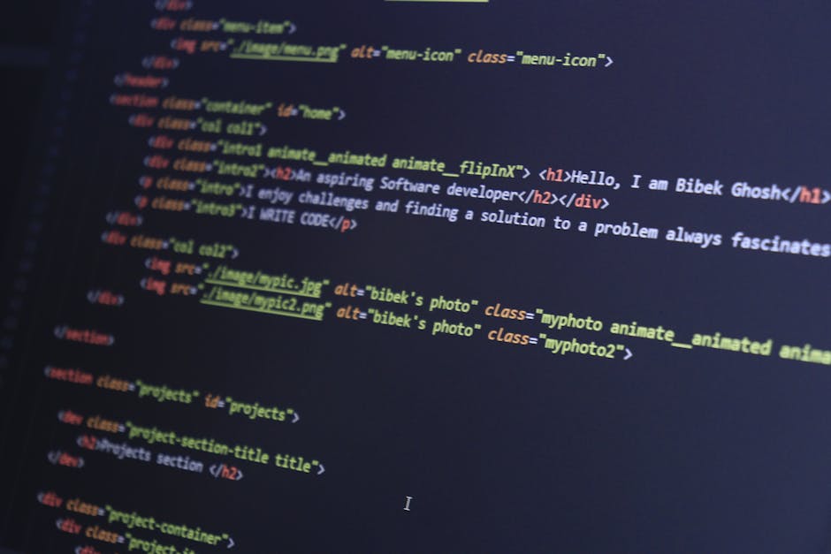 A close-up view of a computer screen displaying HTML code, including tags such as <html>, <head>, <title>, and <link>, with a dark background and colorful syntax highlighting. 